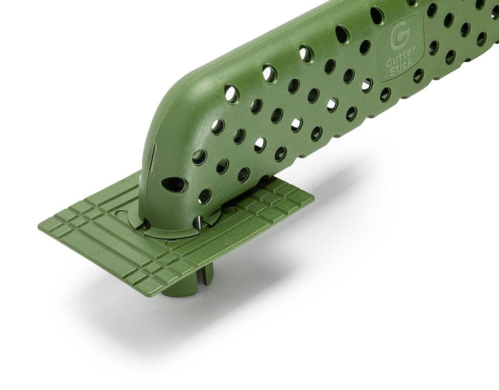 The Gutter Stick manufacturer's product photograph of the green perforated downspout insert and its base plate