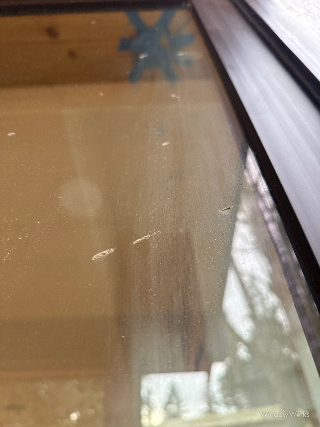 Dried concrete splash bonded to the glass of a sliding door.
