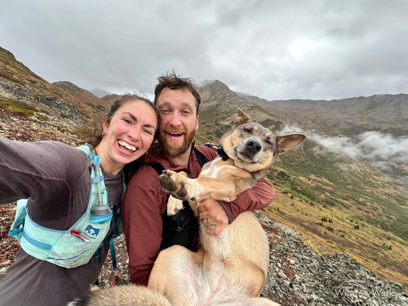 Craig Hauser, owner of WindowWorks, with his wife Shelby and their dog River on a mountain ridge in the Snoqualmie Valley.