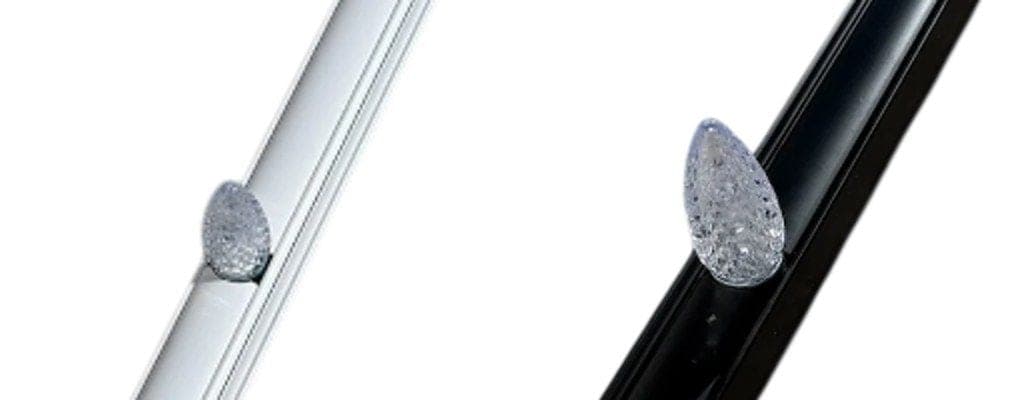 Faceted RGBW C9 bulbs mounted in a white track and a black track.
