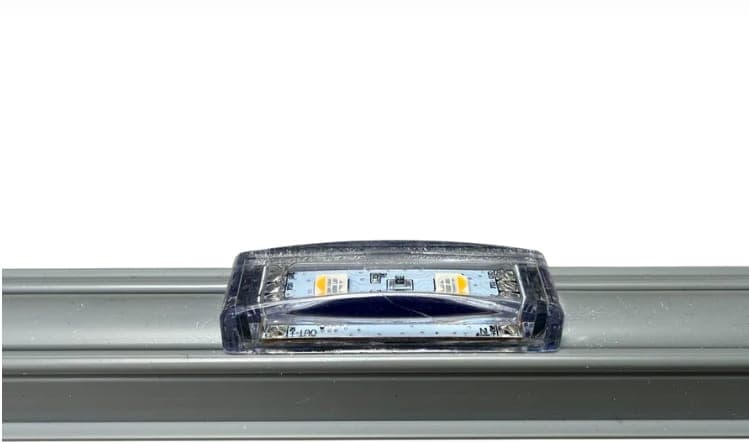 A low-profile Pebble light module seated in its mounting channel.