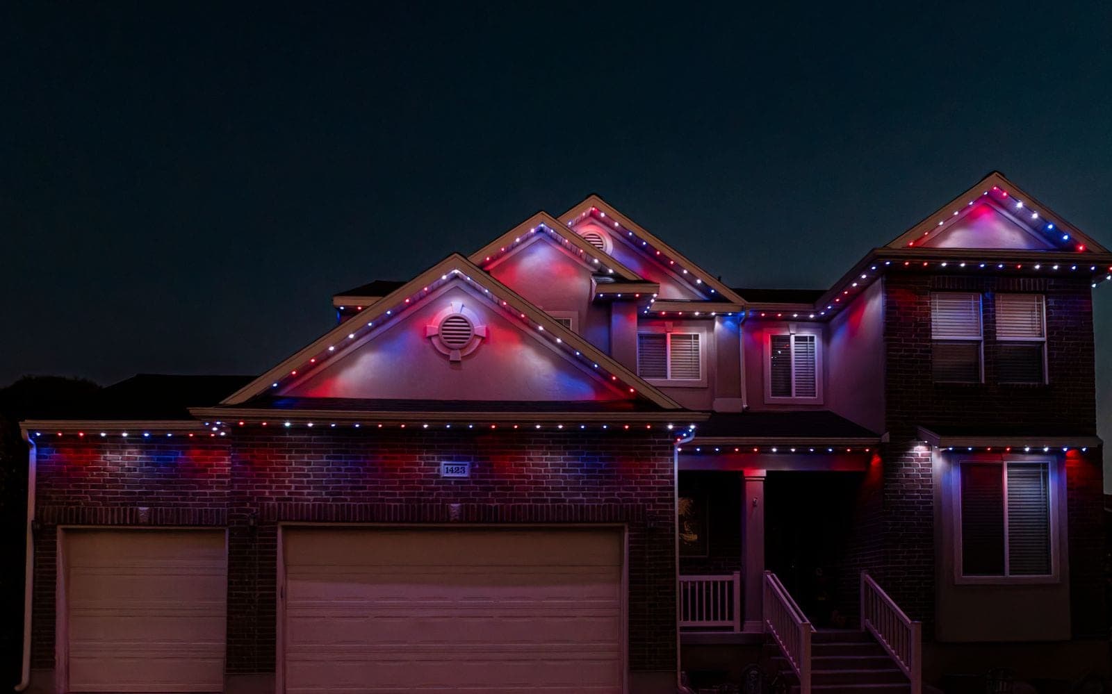 The same home running magenta, purple and red, the gables and garage bays washed in warm pinks.