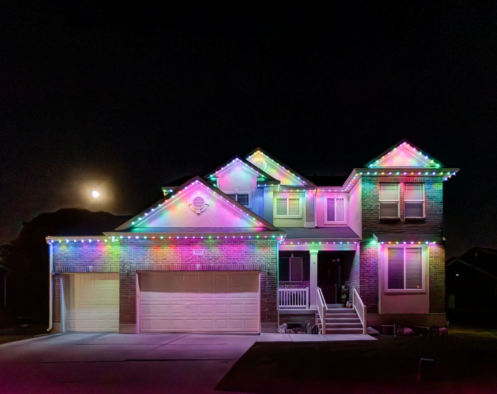 The same home running a pastel pattern of pink, mint, lilac and pale gold along every roofline.
