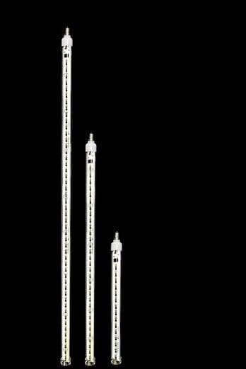 Three cascading snowfall tubes of falling white light at different lengths.