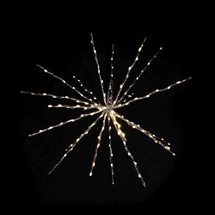 A warm white spritzer starburst lit against a dark background.
