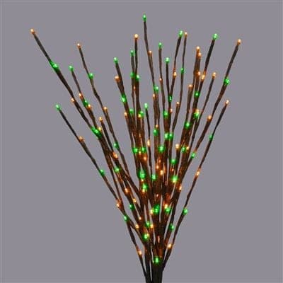 A bundle of lit twig branches with green and orange LED tips.