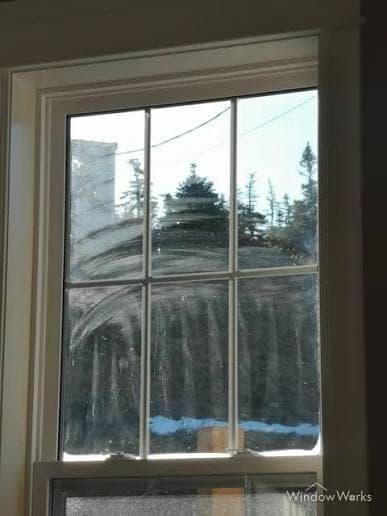 Cloudy streaks and smears left across window panes by a previous cleaning attempt.