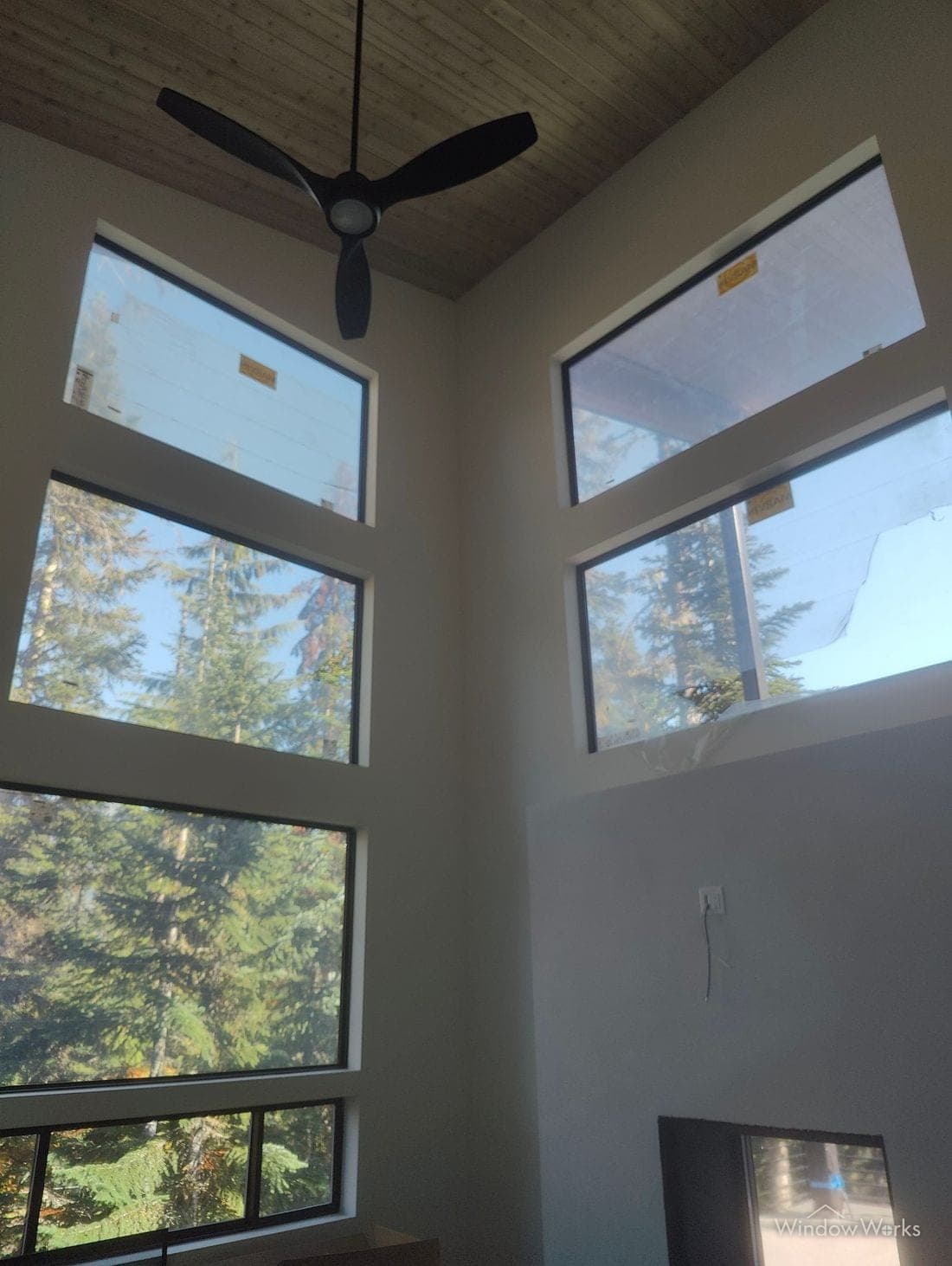 Factory labels and protective film still stuck to the windows of a new build.