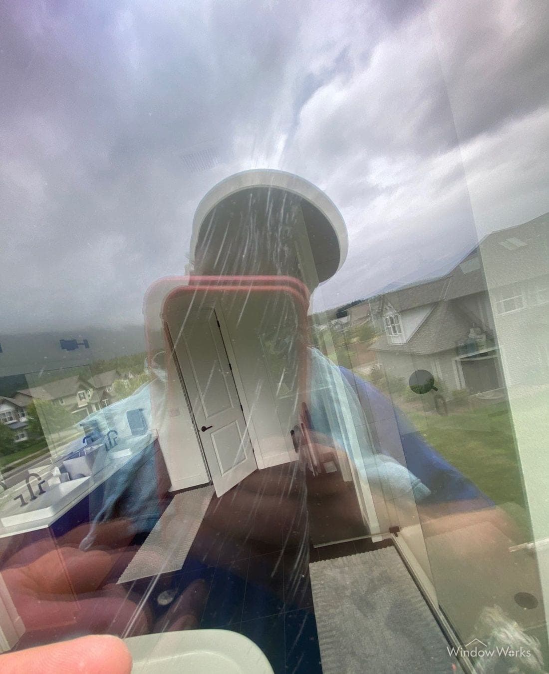 Fine parallel scratches running across a large pane of glass, lit from behind.