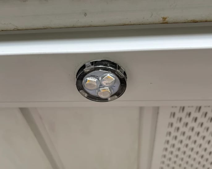 A single puck light set into a white soffit